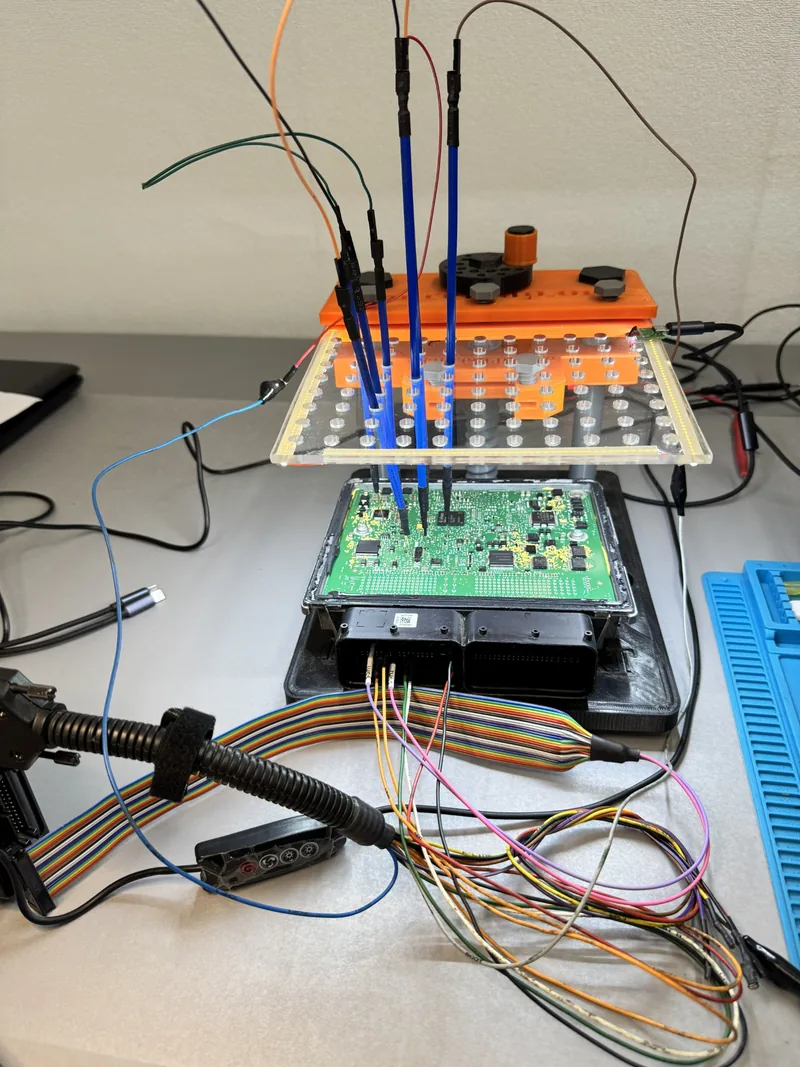 Portrait close-up of Audi Simos ECU circuit board and connected probe fixture