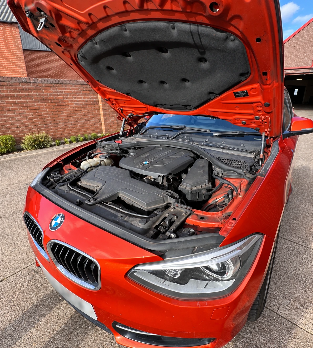 BMW 1 Series prepared for DSC and ABS programming and coding, with registration plate blurred