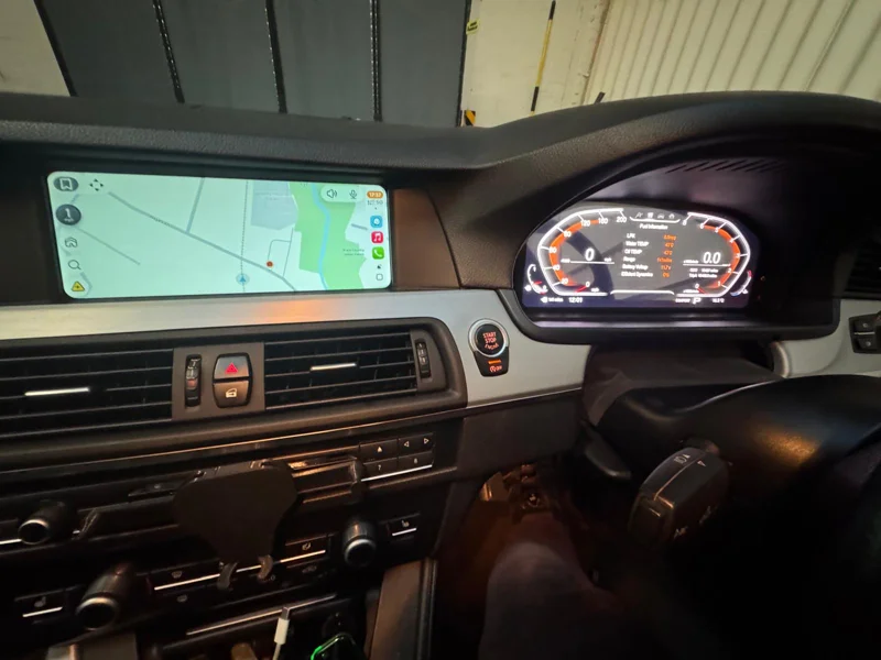 BMW digital instrument cluster installed beside the navigation display