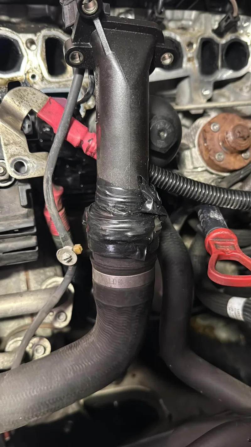 Coolant pipe connection beside the N47 intake ports