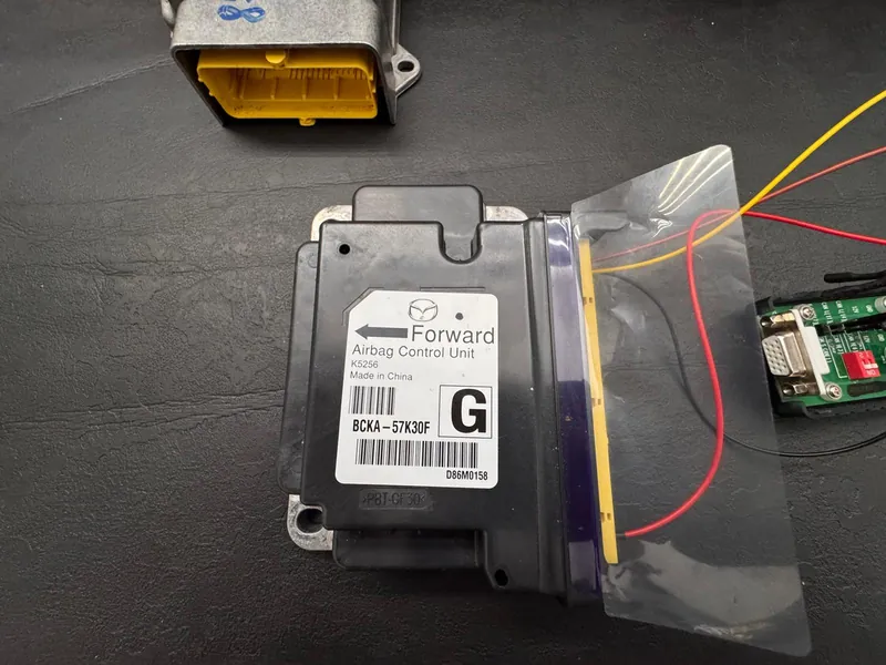 Close view of Mazda airbag SRS control unit BCKA-57K30F with programming wires