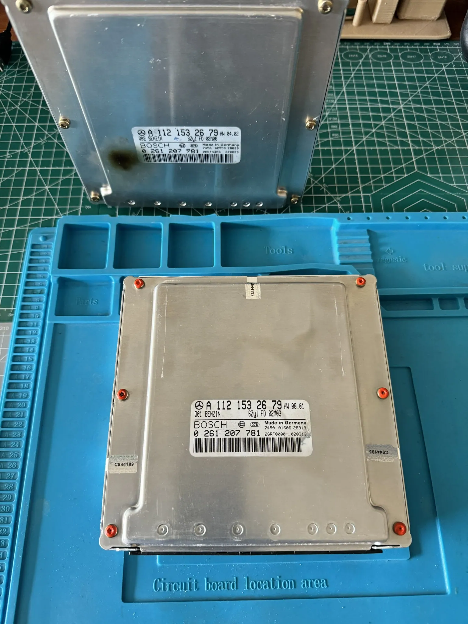Two Mercedes Bosch ME2.8 control units with part-number labels for donor compatibility checks