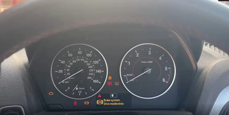 BMW 1 Series instrument cluster displaying the brake system warning before DSC coding