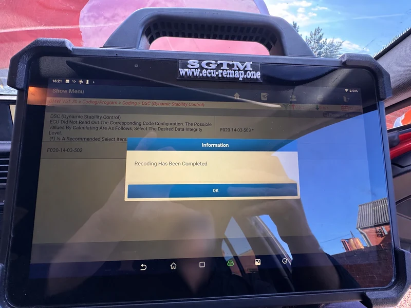 BMW DSC coding screen displaying Recoding Has Been Completed with diagnostic identifiers obscured